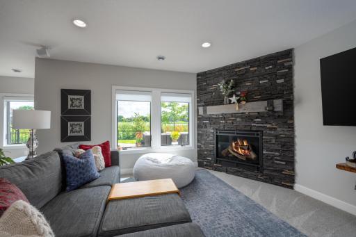 A custom corner stone fireplace makes this space warm and inviting.