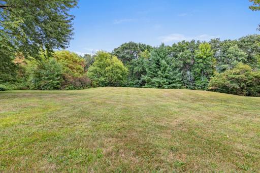 A sprawling yard is ready for gardens, games, pets, or simply enjoying the outdoors.