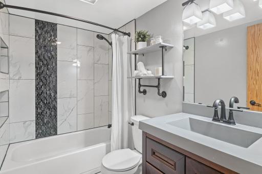 The remodeled full bath brings a fresh finish to the main level.