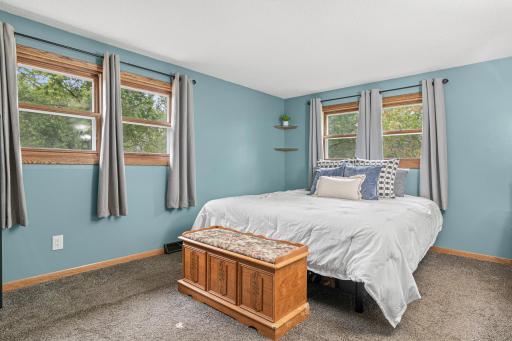 A spacious main-level primary bedroom creates an easy retreat at the end of the day.