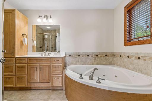 Primary bathroom includes jetted tub and tiled walk in shower