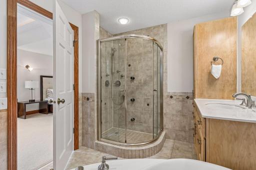Primary bathroom includes jetted tub and tiled walk in shower