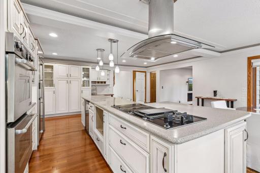 Jennaire Double Ovens, Miele electric cooktop and hood vent as well as Wine Enthusiast 33 bottle wine fridge