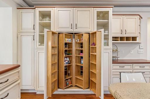 Built in pantry cabinetry with glass front uppers