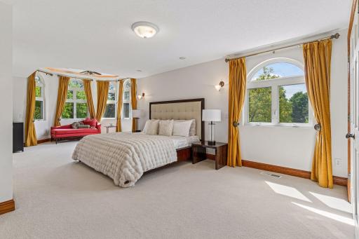 Expansive primary suite complete with two story lounge area and flooded with natural light