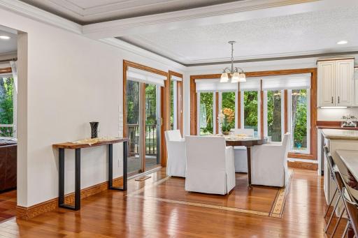 Informal dining space leads directly out to sliding glass door and deck overlooking wooded backyard