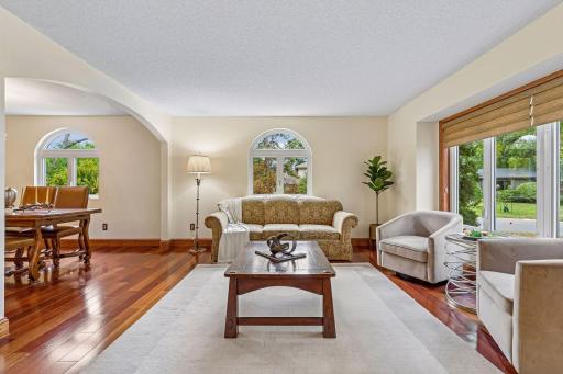 Formal living room opens to formal dining room framed by stunning archways and plenty of natural light.