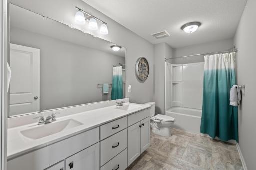 Full upper-level bathroom with double vanity