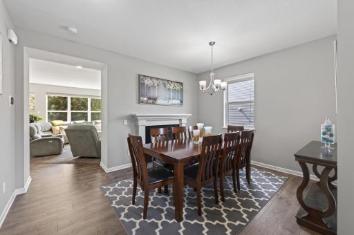 Double-sided gas fireplace connects the dining and living spaces