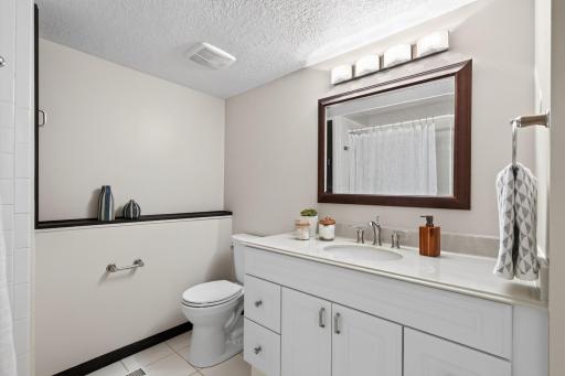 Convenient lower-level full bathroom serves bedrooms and gathering spaces