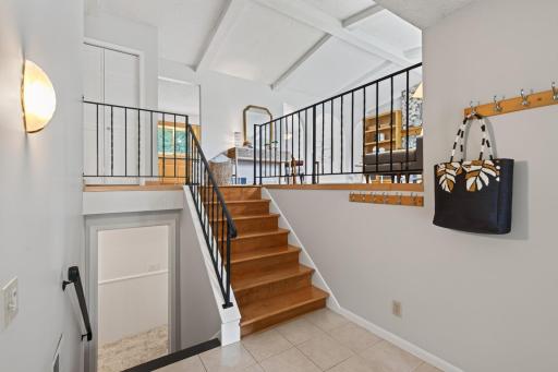 Hardwood stairs and black iron railings introduce the home’s distinctive style