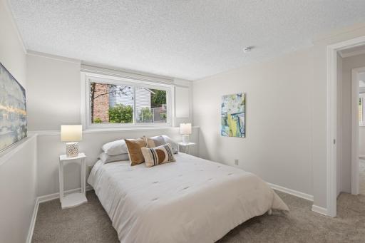 Fourth comfortable lower-level bedroom filled with natural light