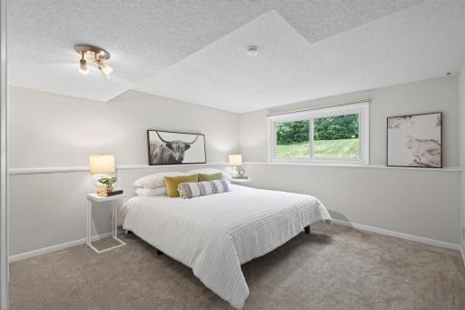 Spacious lower-level third bedroom with natural light