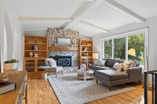 Soaring ceilings, exposed beams, and a brick fireplace make this living room unforgettable