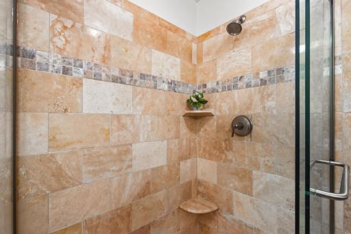 Detailed tilework adds warmth and character to the primary shower