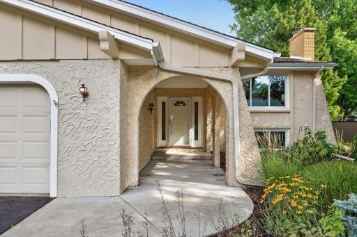 A covered arched entry adds charm and architectural interest