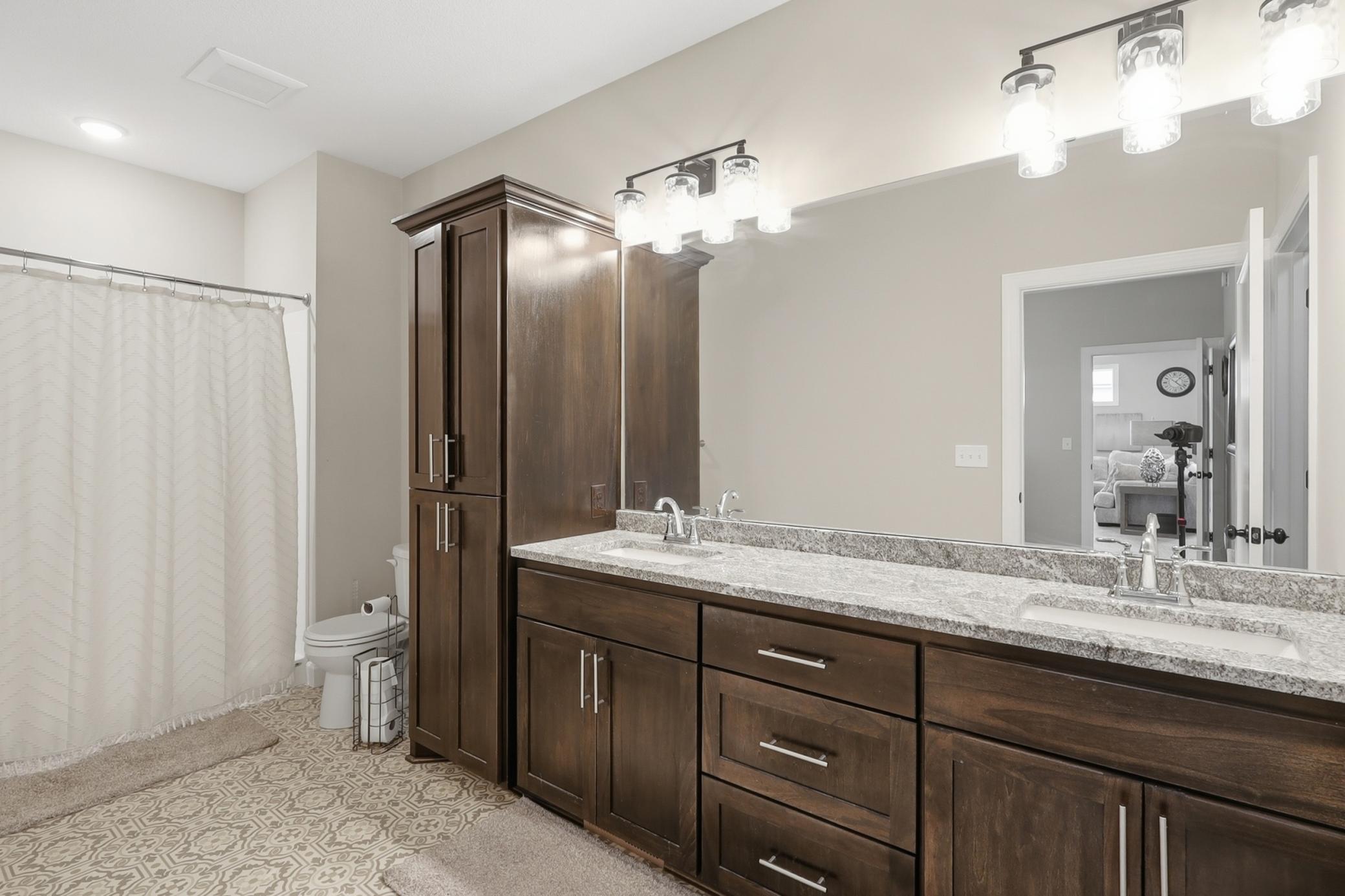 Main Level Primary Full Bathroom with Dual Sinks and Walk in Closet