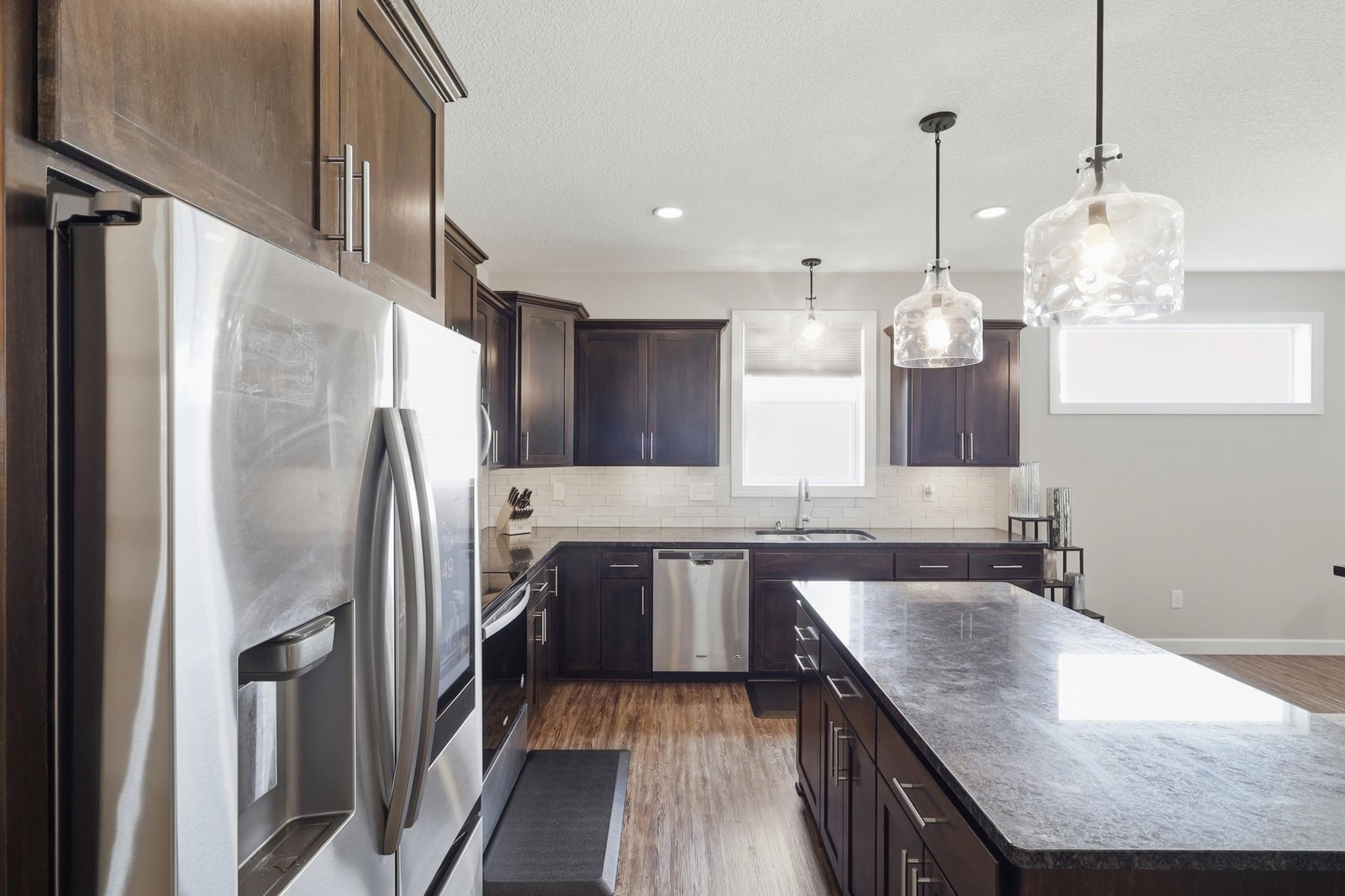 The heart of the home boasts custom cabinetry, granite countertops and SS Appliances!
