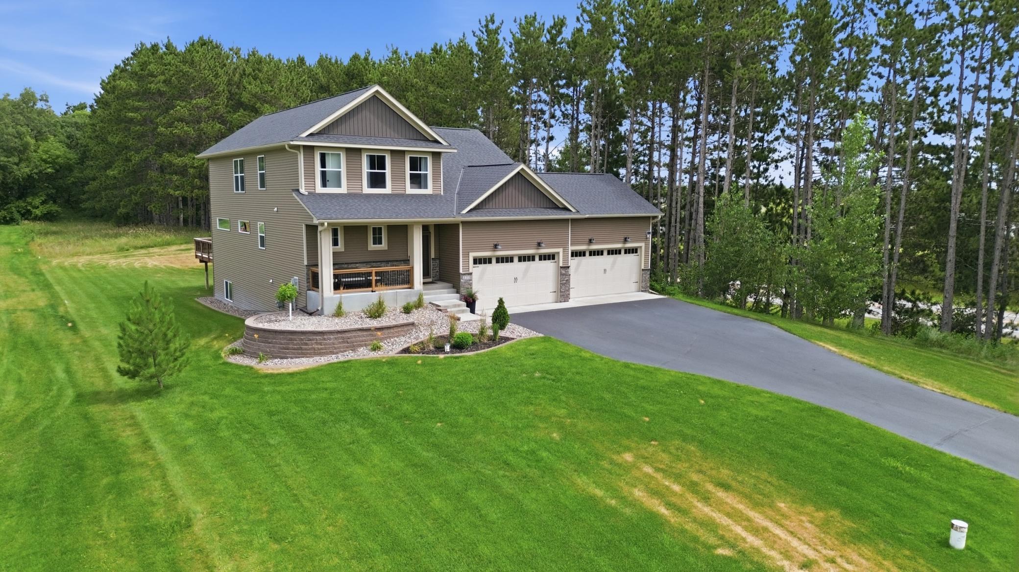 Enjoy professionally completed landscaping with full sod, an in-ground sprinkler system, and a beautiful retaining rock wall, all designed to create a polished, low-maintenance yard
