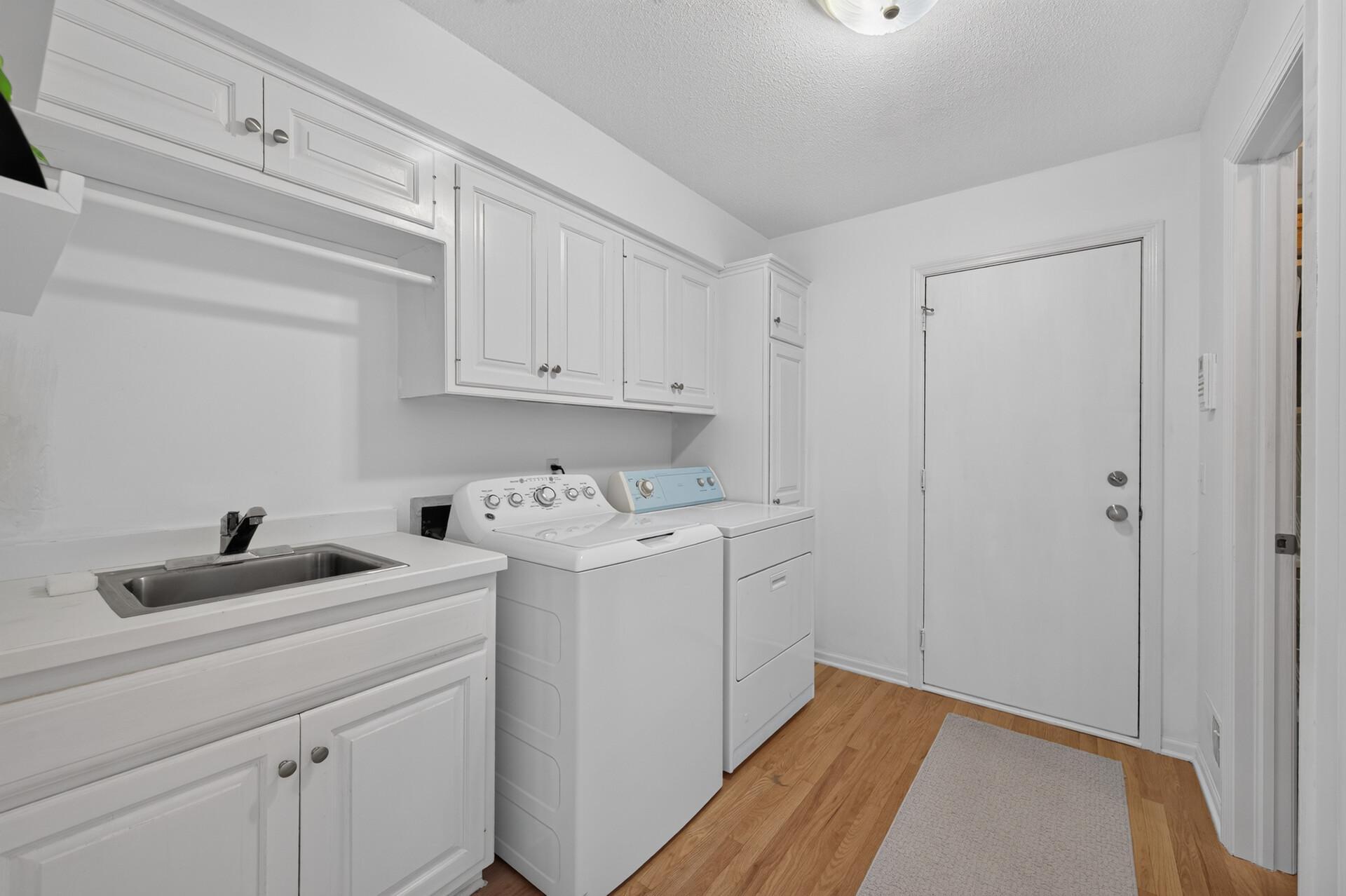 Laundry room is conveniently located by the garage entry.