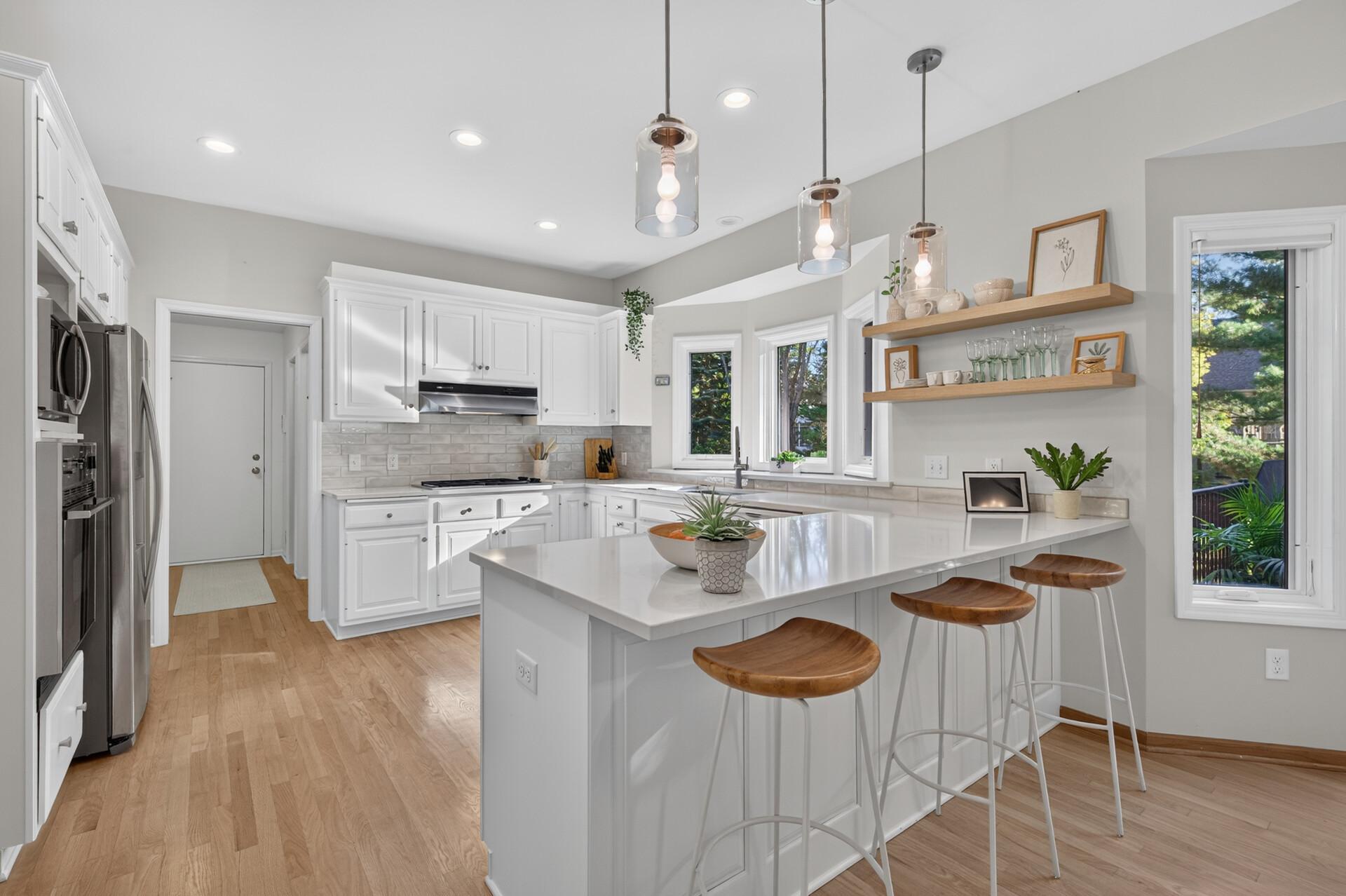 Beautifully updated counters, cabinets, backsplash and lighting make this a lovely place to entertain and prepare family meals.
