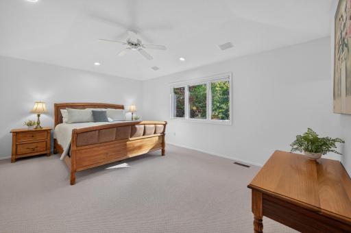 The primary suite is large and features windows with views of the beautiful backyard.