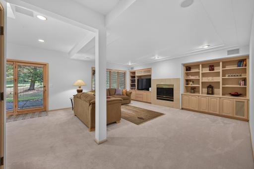 Large windows, high ceilings make this lower level family room feel open and spacious.