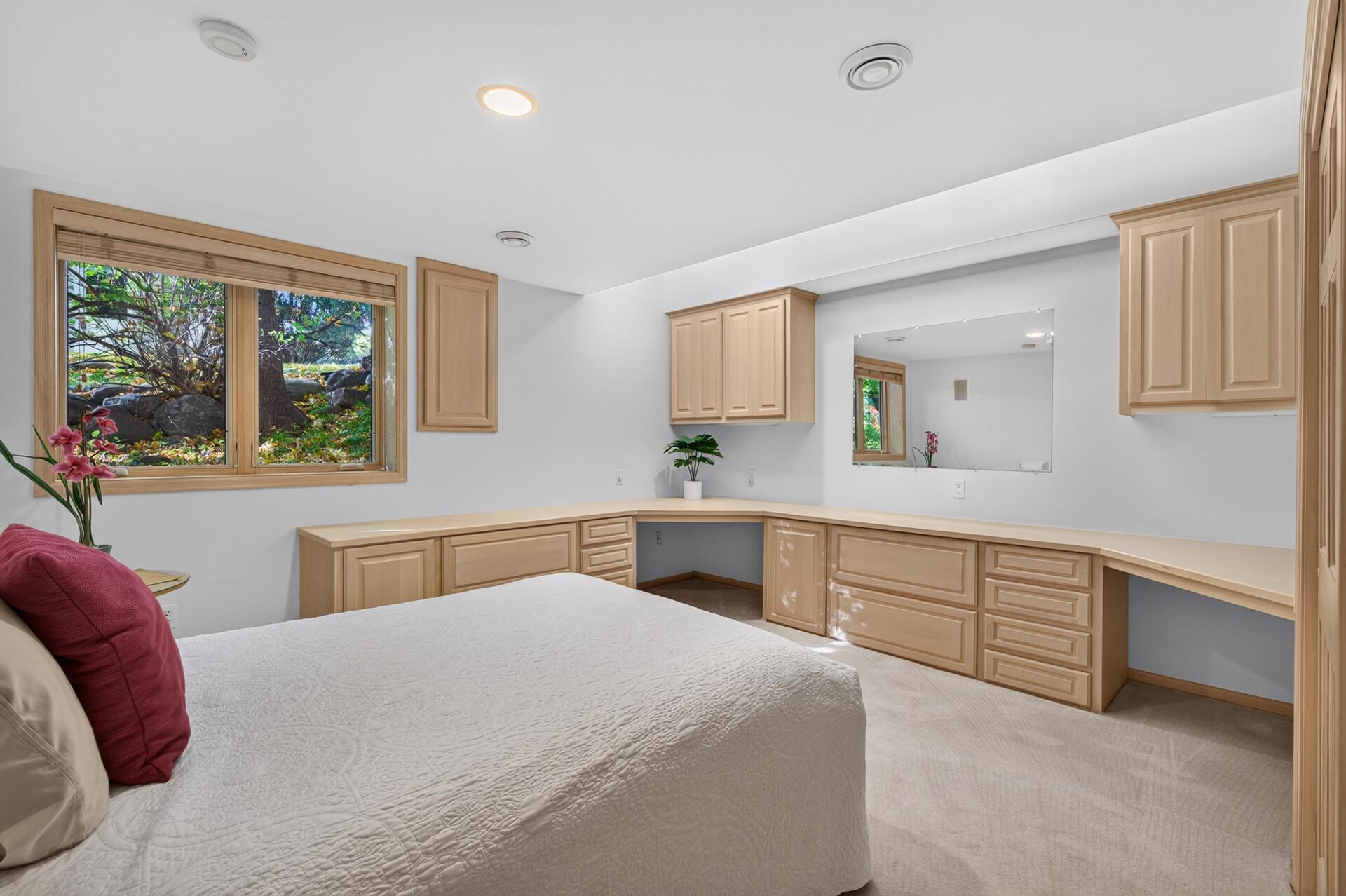 Bedroom 5 in the lower level features large lookout window and built-ins.
