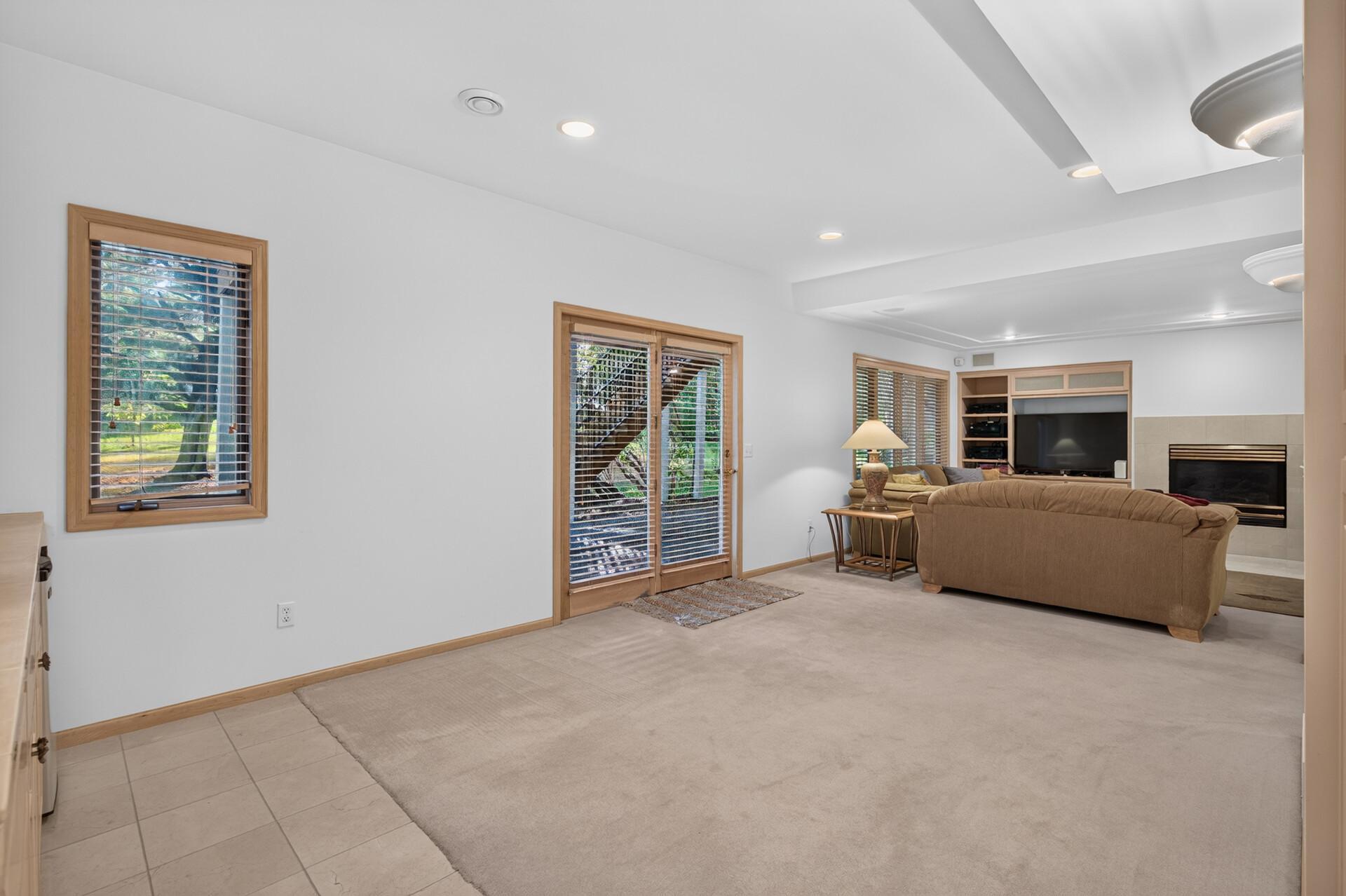 The glass doors open to the beautiful backyard and patio area.
