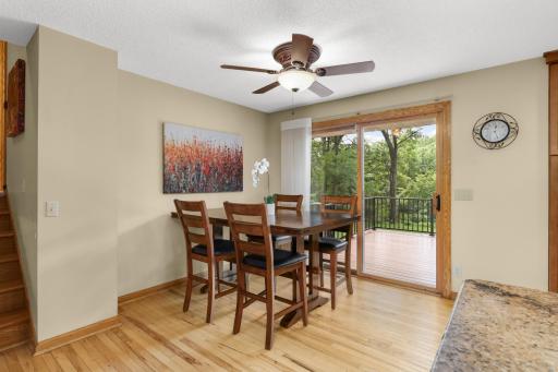 The main living level features warm hardwood floors and an inviting flow between the spacious living room and outdoor living spaces.