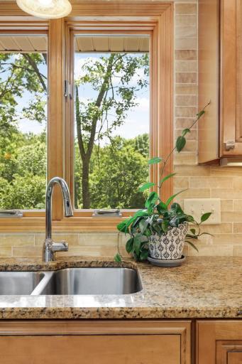 The heart of the home is the amazing updated kitchen, thoughtfully positioned to overlook the backyard and natural surroundings.