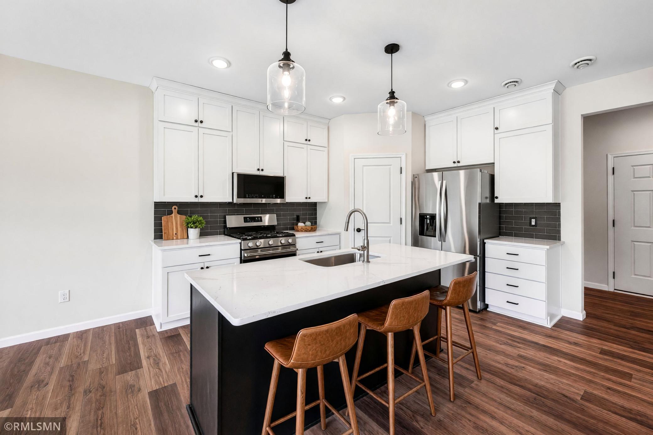 Virtually Staged - Spacious kitchen with large center island and ample cabinetry