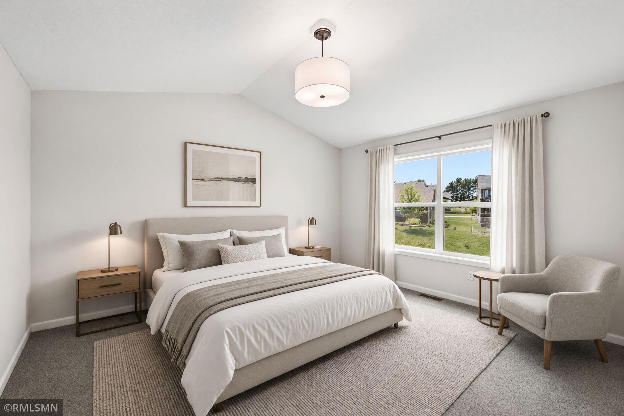 Virtually Staged - Spacious primary suite with vaulted ceiling, large windows, ensuite and 12 foot walk in closet!