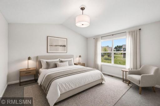 Virtually Staged - Spacious primary suite with vaulted ceiling, large windows, ensuite and 12 foot walk in closet!