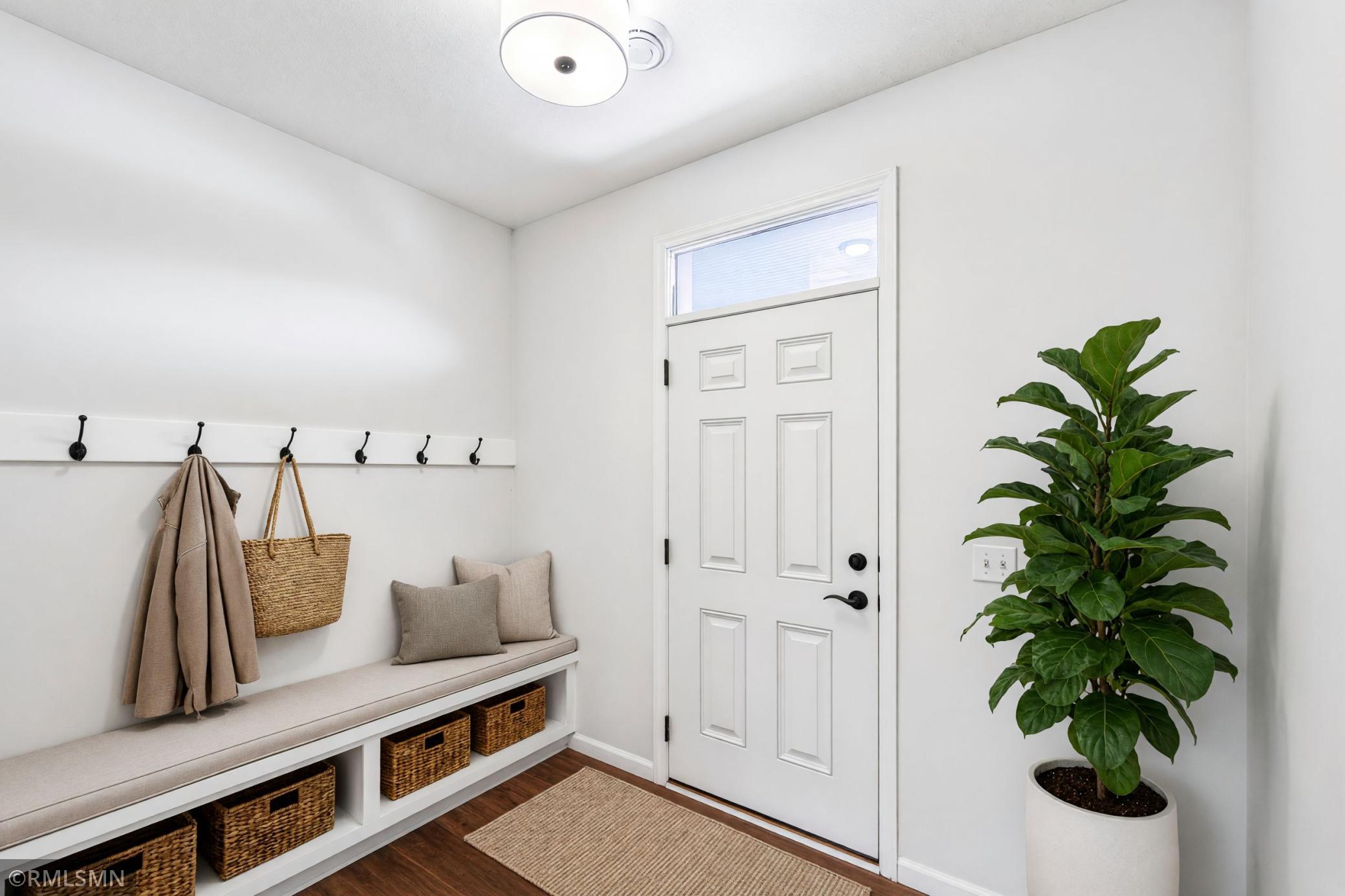 Virtually Staged - Functional entry with built-in bench, storage and six wall hooks
