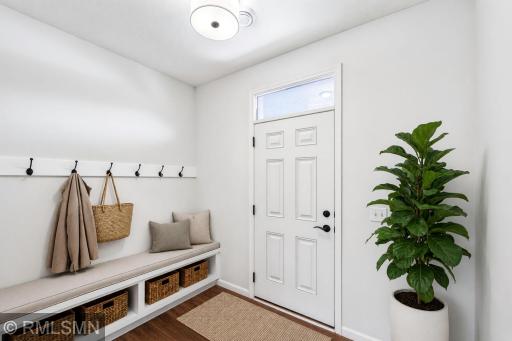 Virtually Staged - Functional entry with built-in bench, storage and six wall hooks
