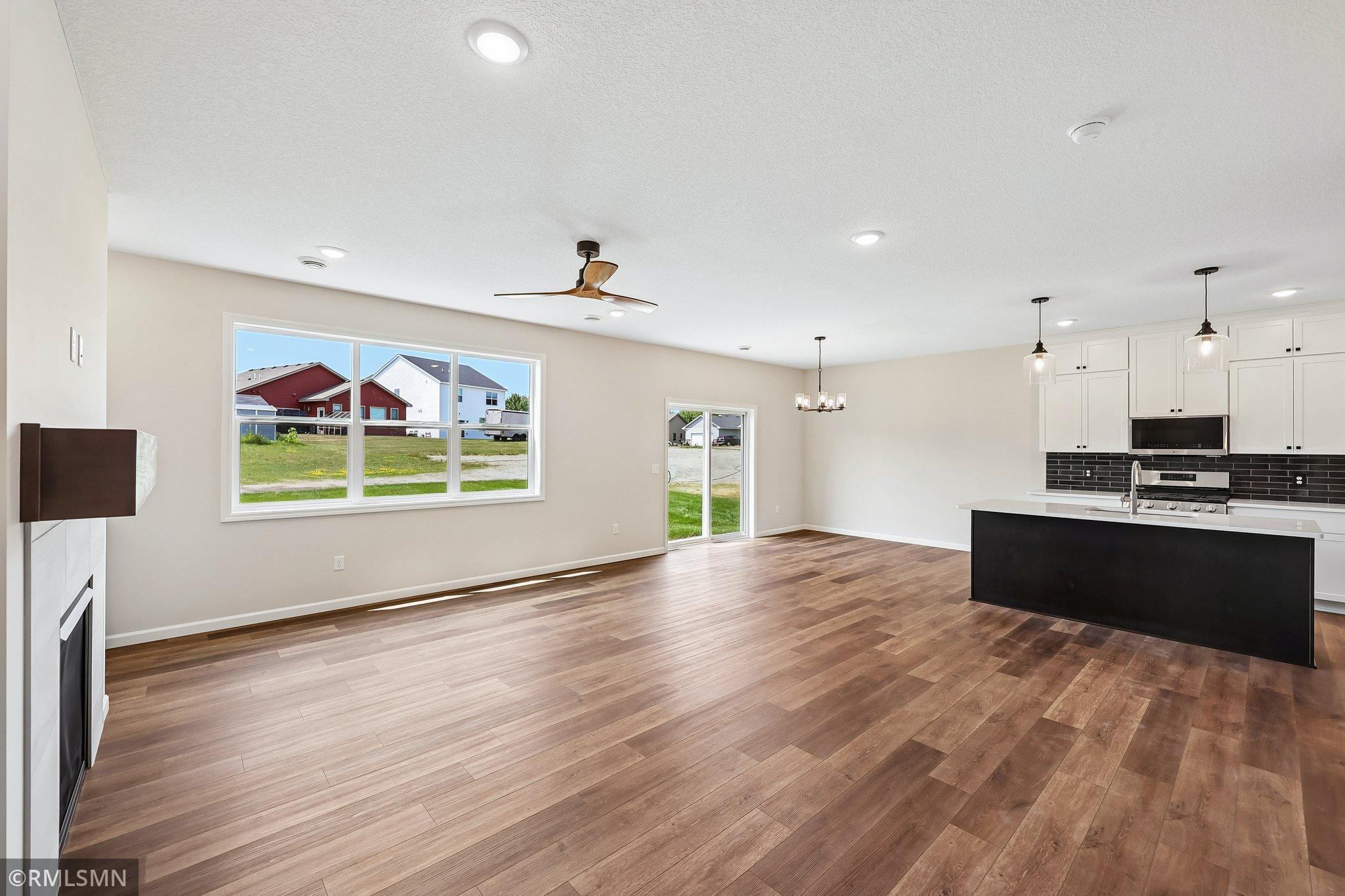 Open-concept layout connecting the kitchen, dining and living spaces