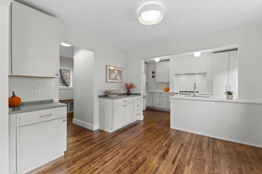Completely renovated kitchen with abundant storage, quartz counters, and stainless steel gas range.