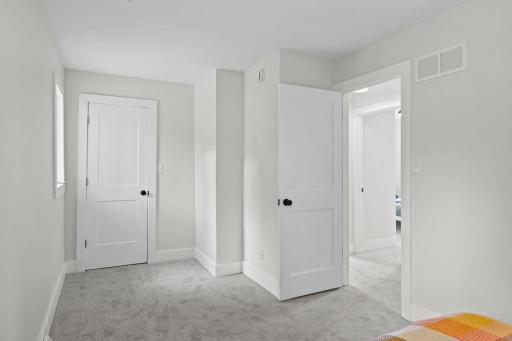 Primary bedroom with a large closet, and brand new carpet.