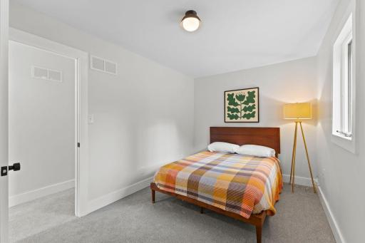 Spacious upstairs primary bedroom with abundant natural light and updated finishes.