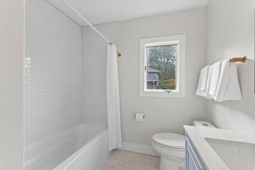 Upper level bathroom features modern design and welcoming space..