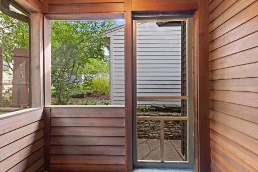 Charming screened porch provides peaceful retreat and seamless indoor-outdoor connection.