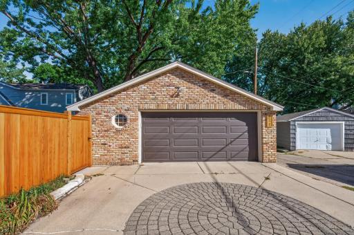 2 1/2 car garage with concrete driveway and brick front