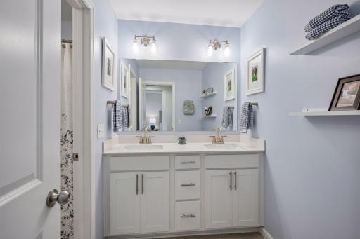 The third bathroom off of the upper level hall features a double vanity and is a full bath.