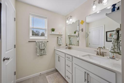 It features a double vanity, walk-in shower, and private toilet closet.