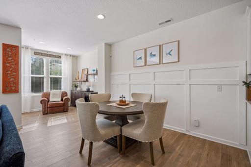 The dining room is situated between the kitchen, living, and sun room.