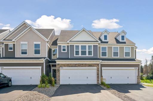 The front of the home features a private entry and an asphalt driveway.