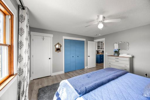 Main floor primary bedroom is right off of the kitchen and the large 3 windows bring in a lot of natural light.