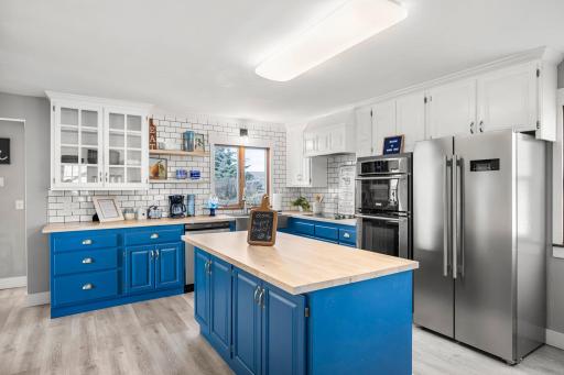 Nice large open renovated kitchen with stainless steel appliances and a large farm sink.