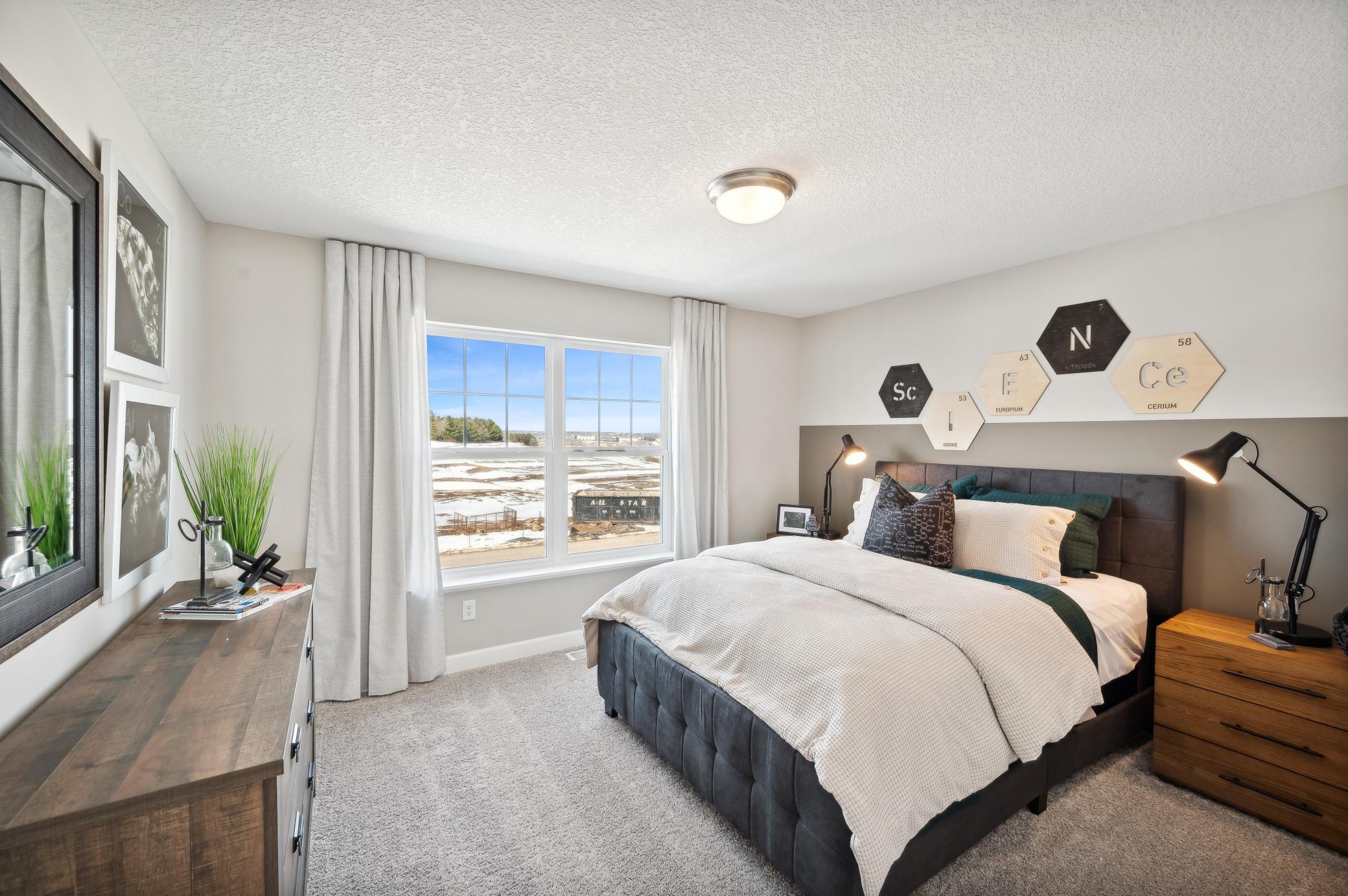 (Photo of model home, finishes will vary) One of the three generously sized upper level secondary bedroom with a spacious closet.